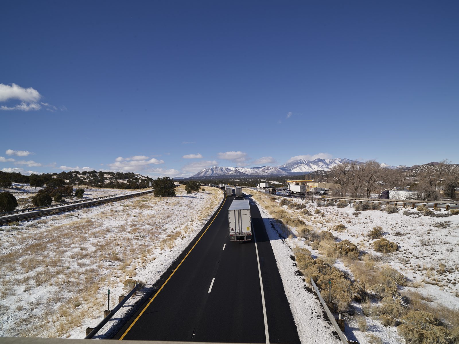 A truck on Interstate 40 in Arizona, mountains ahead
